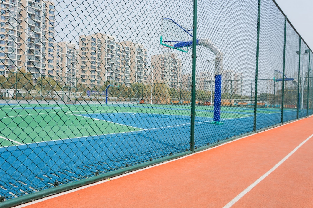 Sports fence suppliers in UAE installing chain link fencing for a multi-purpose sports ground
